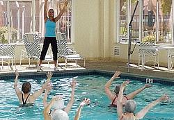 Residents doing water aerobics in the community pool 