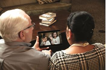 Grandpa and Grandma face-timing with their granddaughters on an iPad