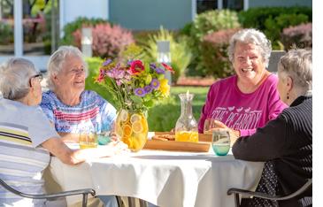 Four women socializing on the patio