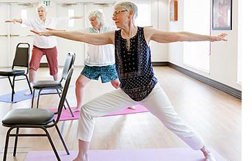 Three women stretching in a yoga class
