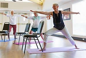 Three women stretching in a yoga class